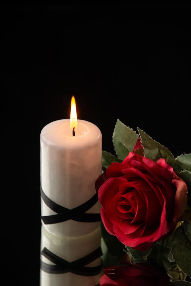 Memorial candle and rose